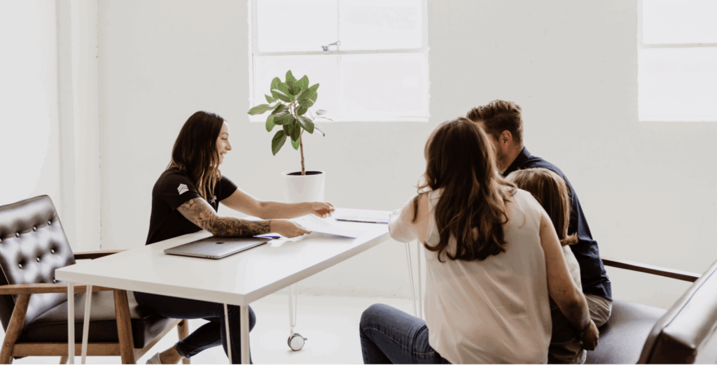Service member reviewing VA loan benefits and home-buying options with a CalzaCo real estate expert near Luke AFB.