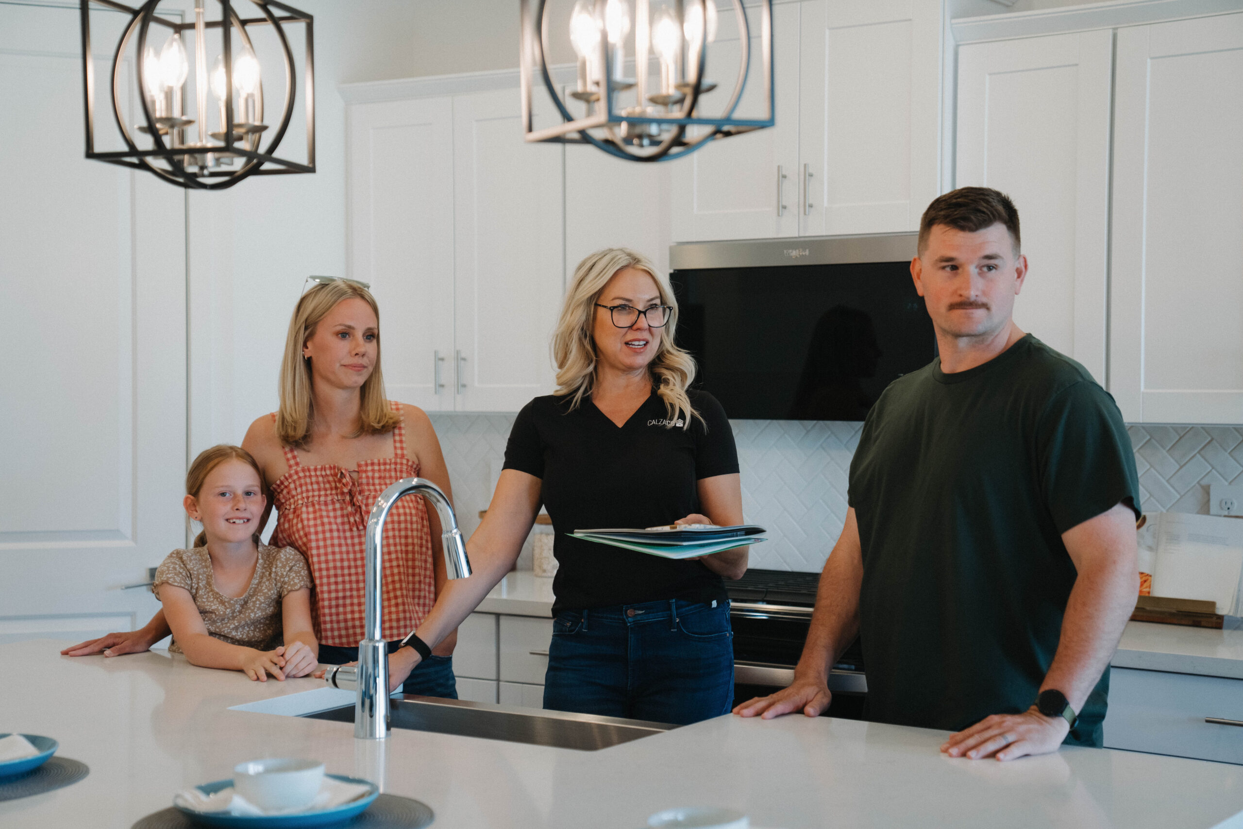 CalzaCo agent reviewing what to fix before selling with homeowners in their West Valley Phoenix home