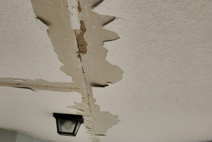 Peeling paint on a covered patio ceiling, a common condition on West Valley Phoenix homes before listing
